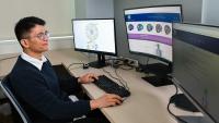 Researcher looking at computer screen.
